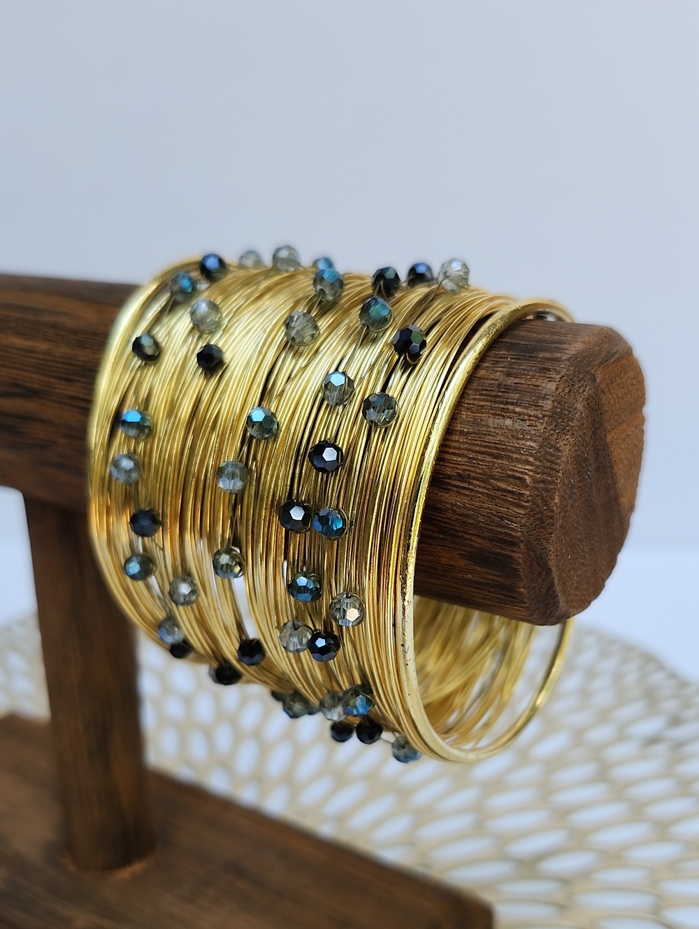 GOLD TONE WIRE WRAPPED STATEMENT CUFF BRACELET WITH BLUE FACETED STONES